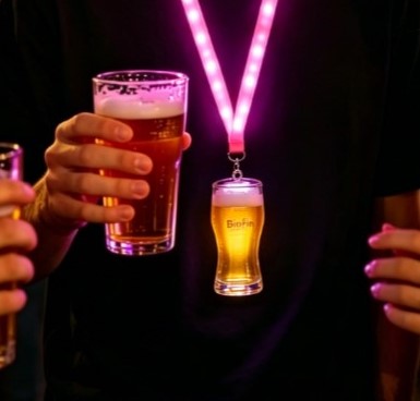 Music festival attendees wearing glowing acrylic LED badge lanyards as interactive souvenirs