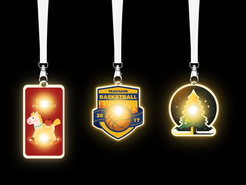Concert fans wearing artist logo shaped acrylic LED badges as tour merchandise