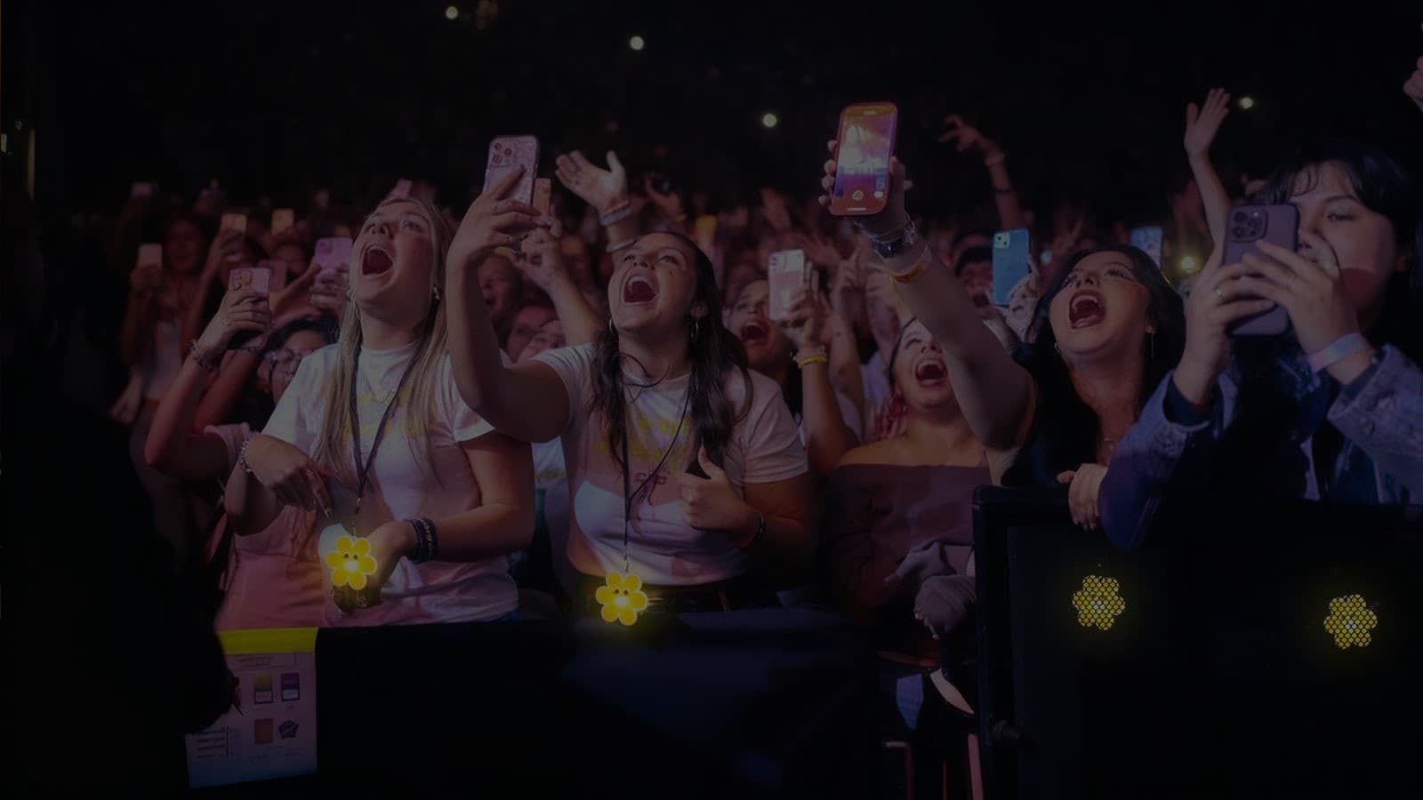 Music festival crowd with colorful LED lanyards glowing at night