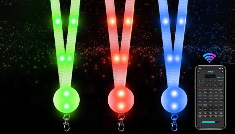 Event attendees using branded mobile app to control their LED lanyard colors during interactive show moment
