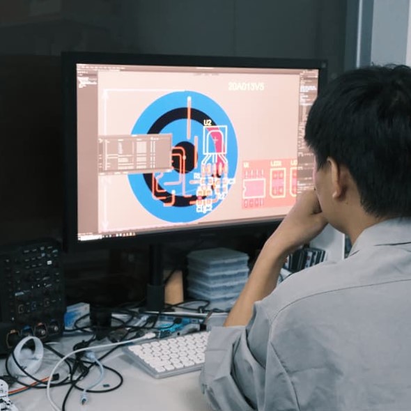 Electronics development laboratory showing engineers testing new wireless chips and firmware upgrades
