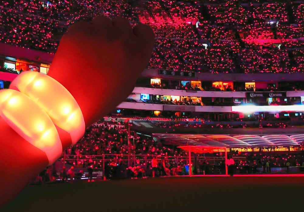 Vibrant fields of high-intensity luminous flashing bracelets blinking together across a packed live tournament stadium