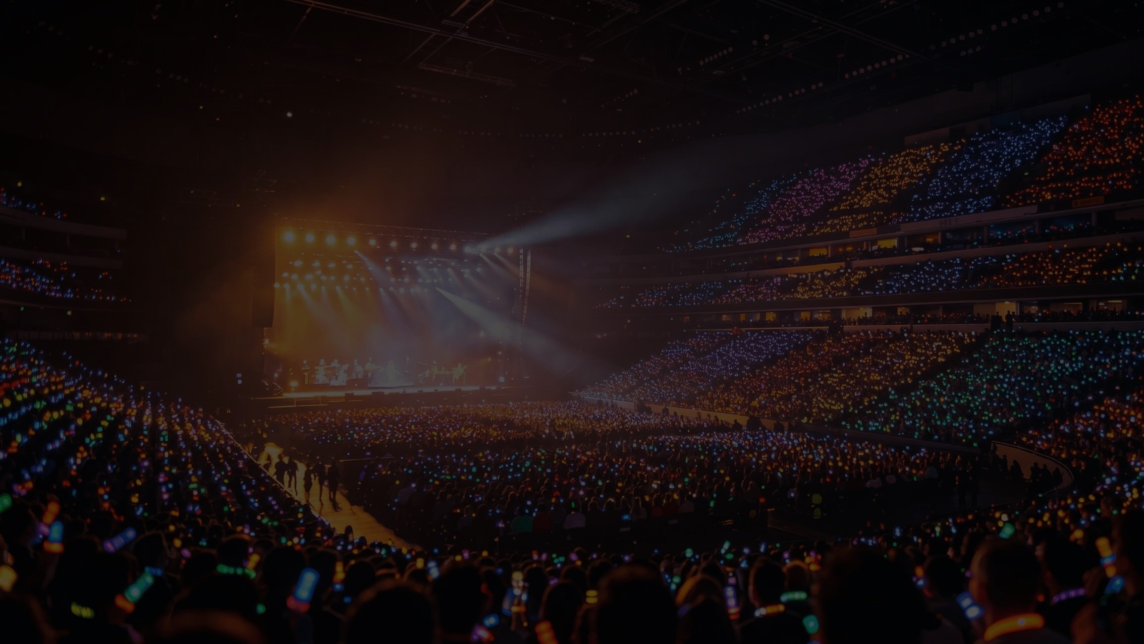 Large concert crowd with stage lights
