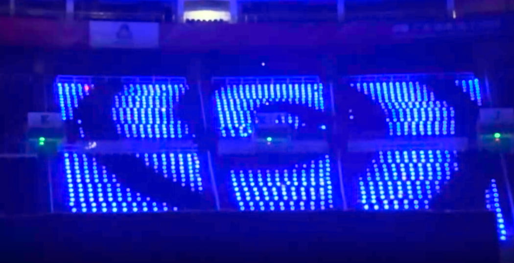 Smooth RGB color gradient shifts over large arena crowd with LED wristbands