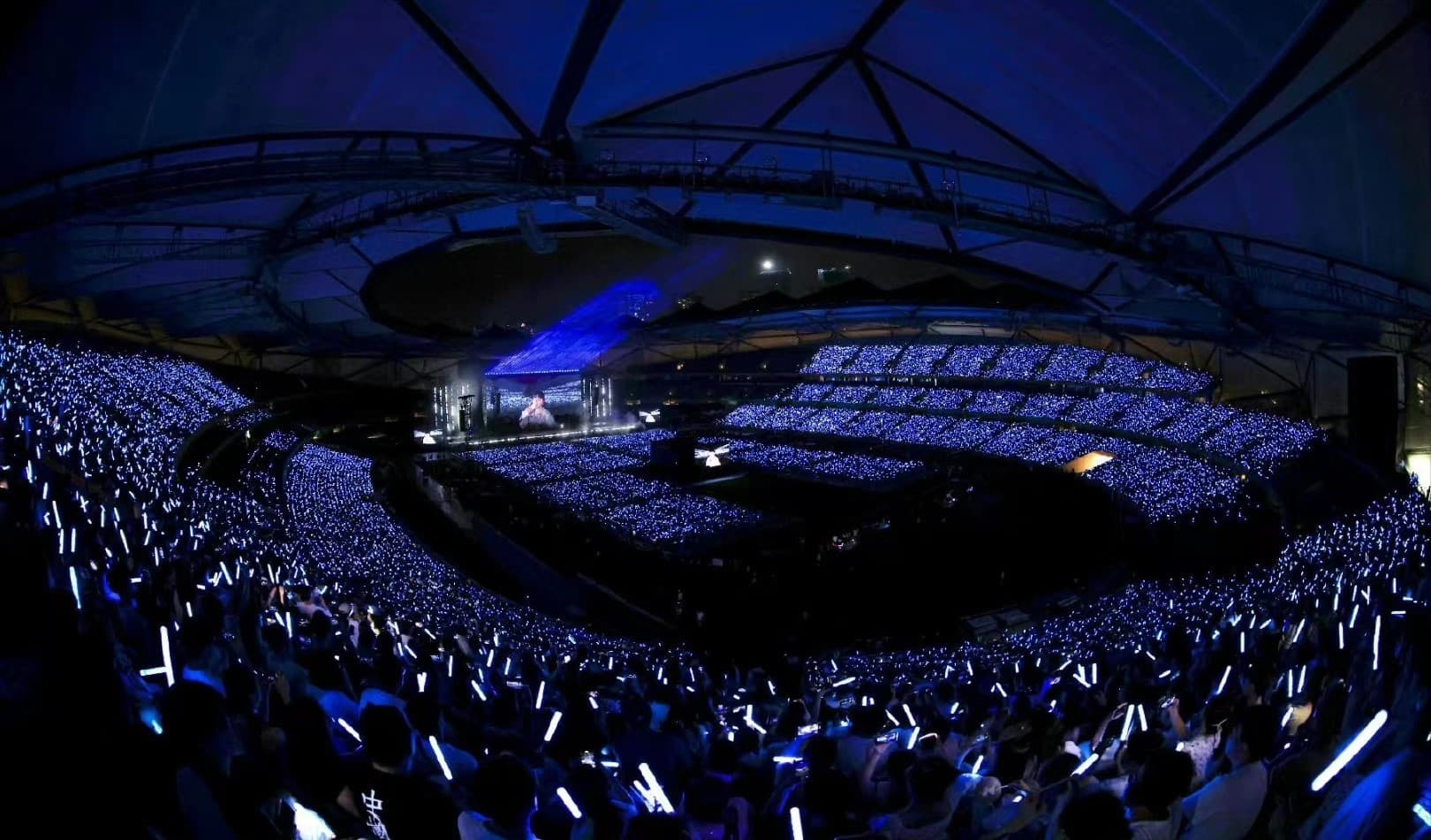 LED light up lanyards glowing across an event audience in synchronized colors at night