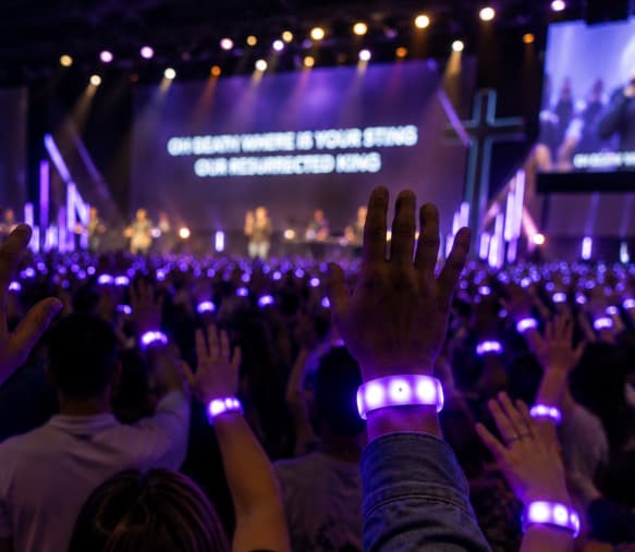 Worshippers wearing synced LED wristbands